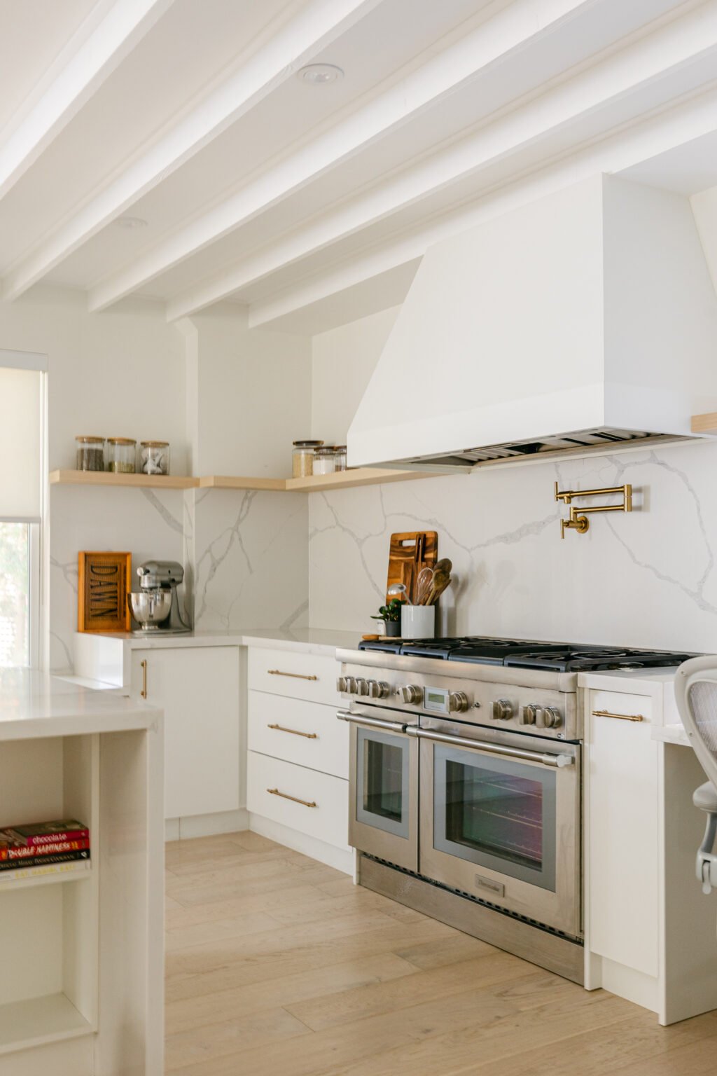 White marble kitchen with brass fixtures
